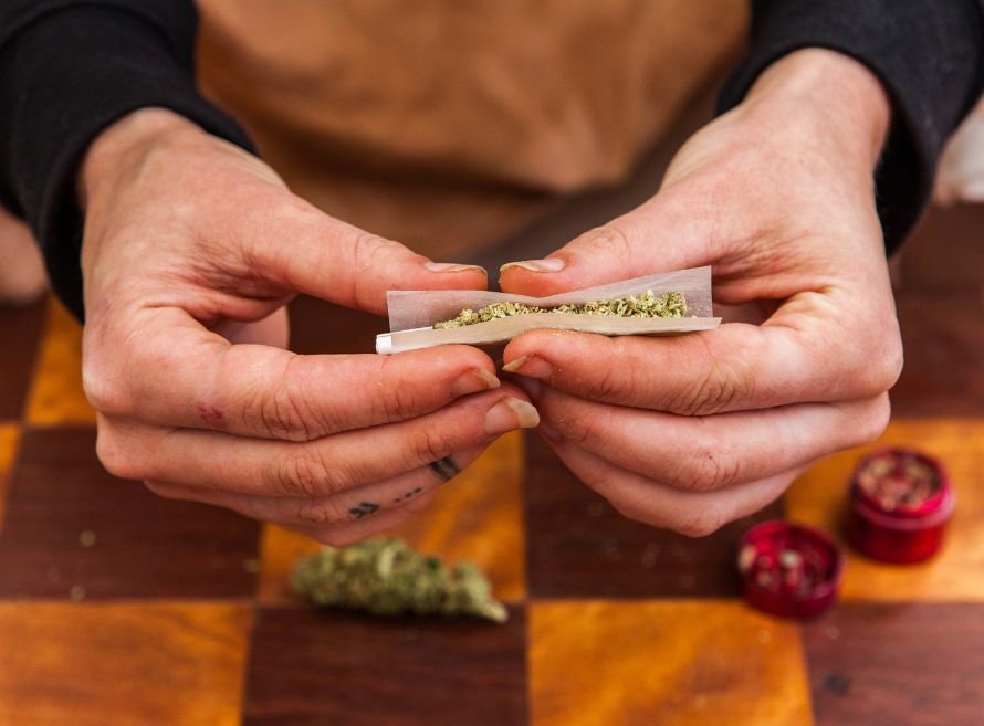 guy rolling up cannabis